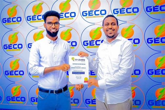 U-Learn Skills graduates holding their certificates at a graduation ceremony